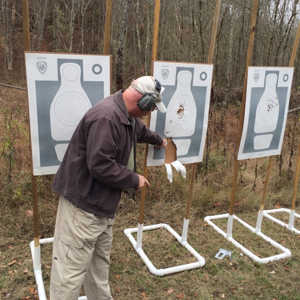 Tom Givens demonstrating what the gasses from the cylinder gap will do.  He turned the target and held the revolver along side of it and fired a shot.